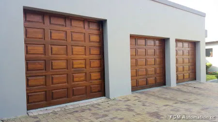 Three blocked wooden garage doors in different sizes